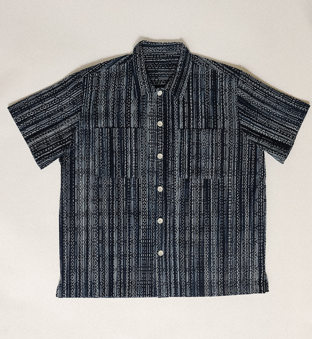 Black and white striped shirt on a light beige background