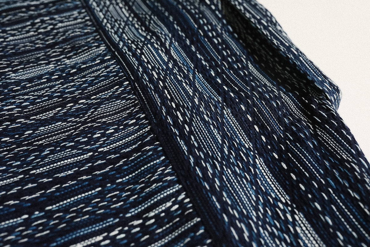 Close-up of dark blue fabric with a textured pattern