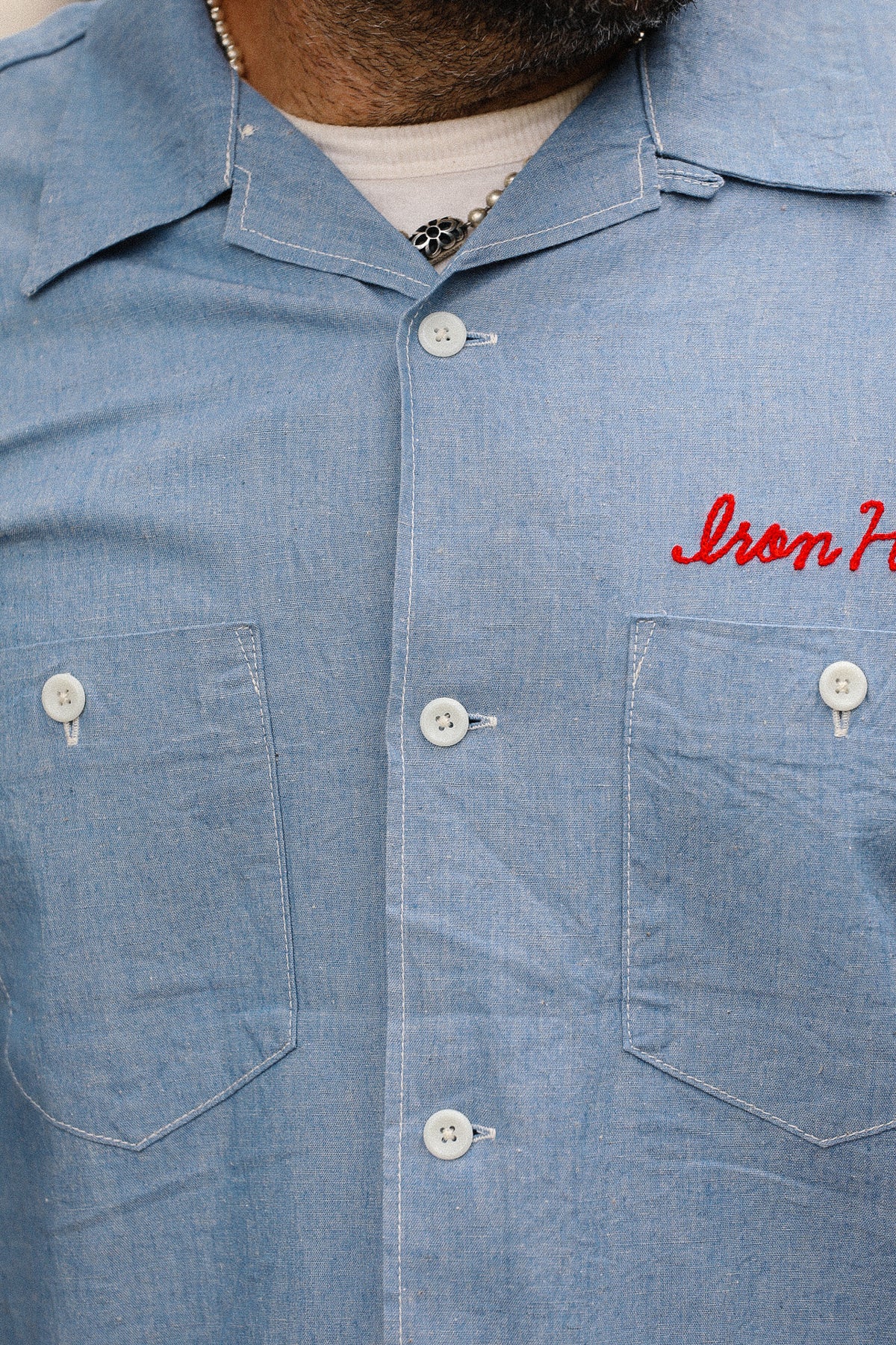 Blue denim shirt with 'Iron Horse' embroidery on a white background
