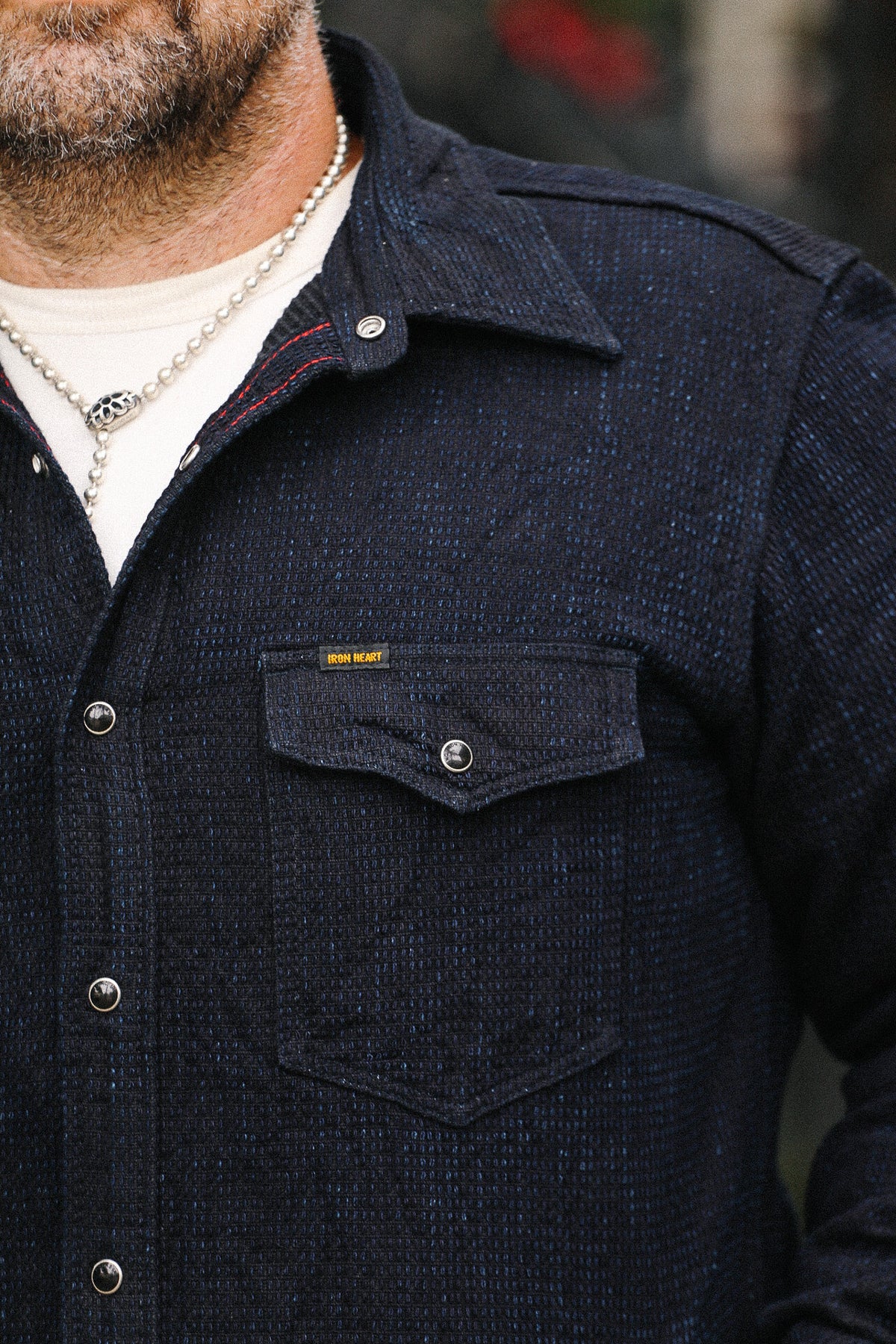 Navy blue jacket with a visible brand logo on a blurred background