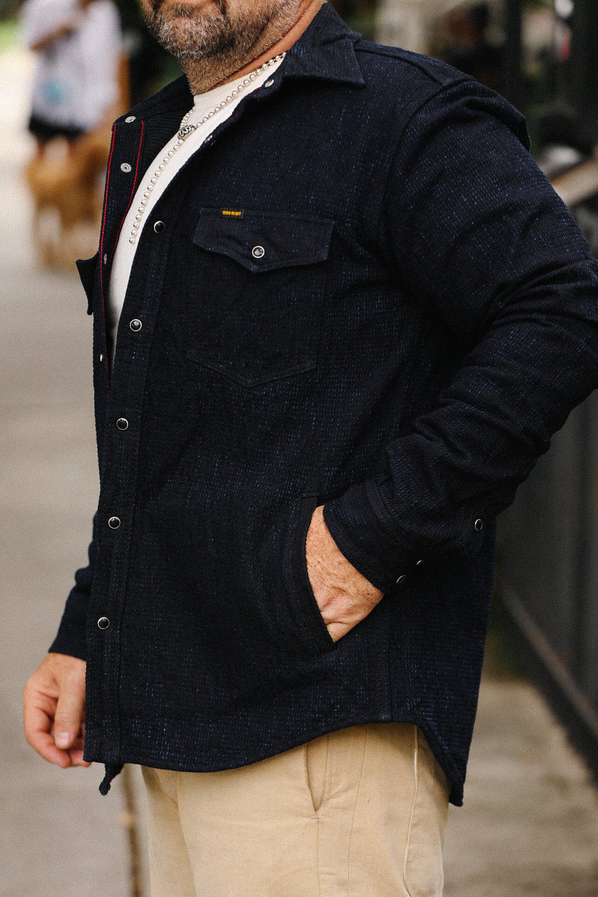 Man wearing a dark jacket with a blurred background