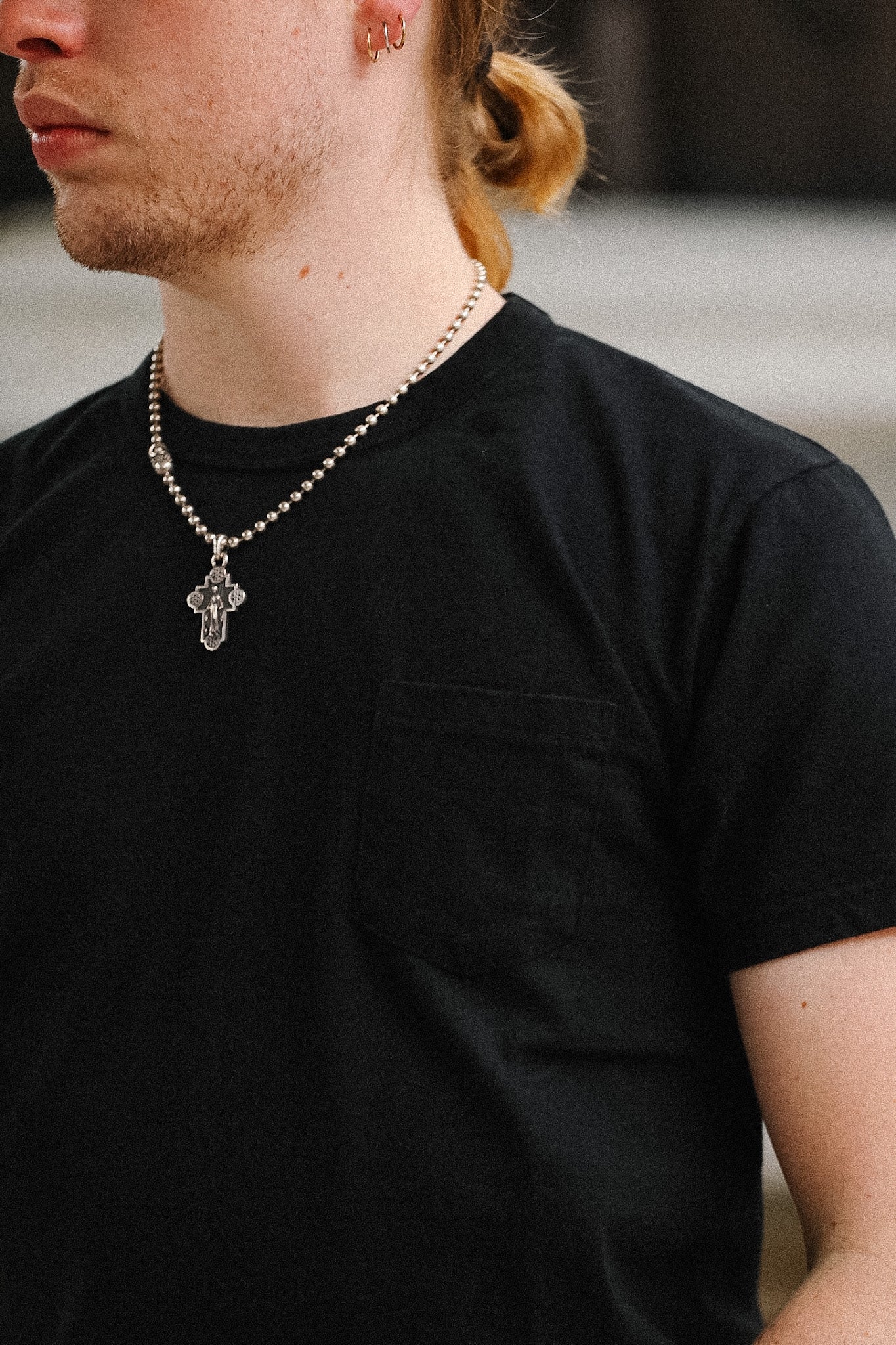 Man wearing black t-shirt on blurred background 