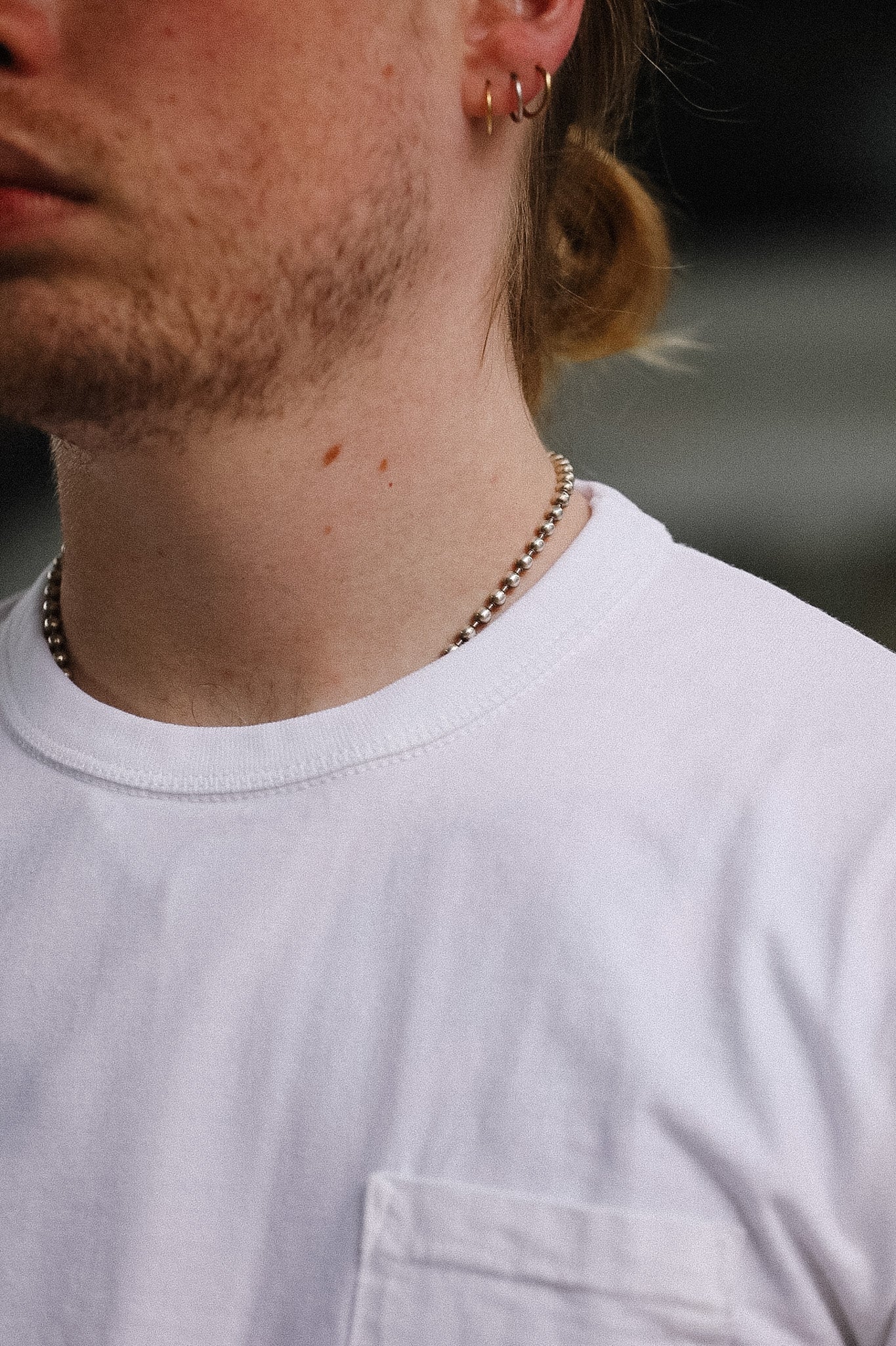 Close-up of a light gray t-shirt with a pocket