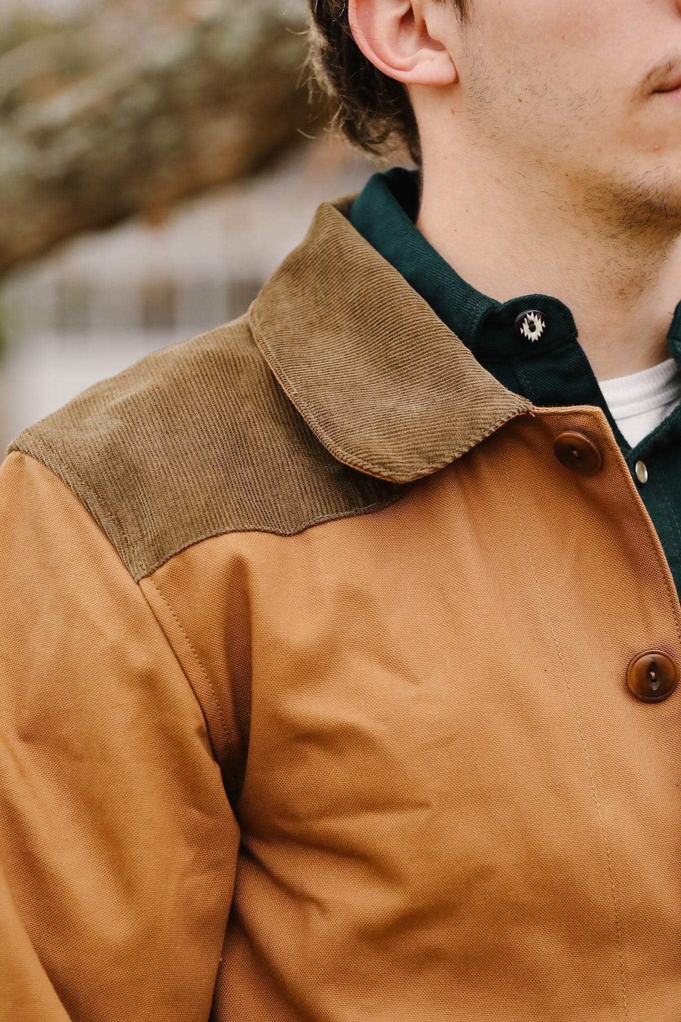 Close-up of a brown jacket with a blurred natural background