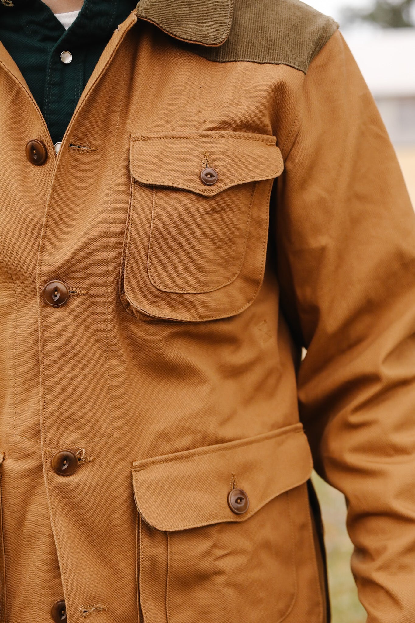 Close-up of a brown jacket with button details