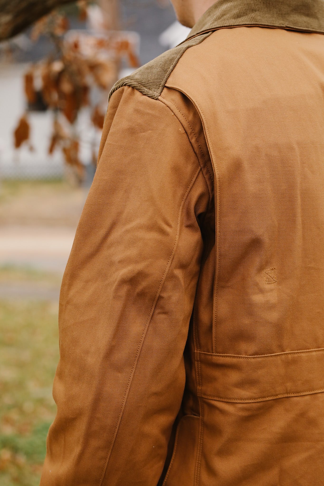 Close-up of a brown leather jacket with a blurred background