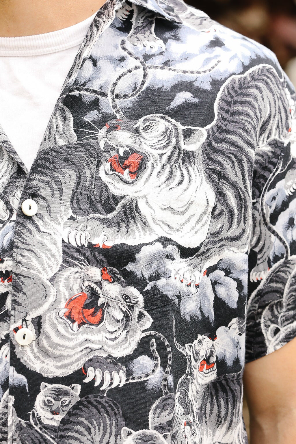 Person wearing a black shirt with white tiger designs