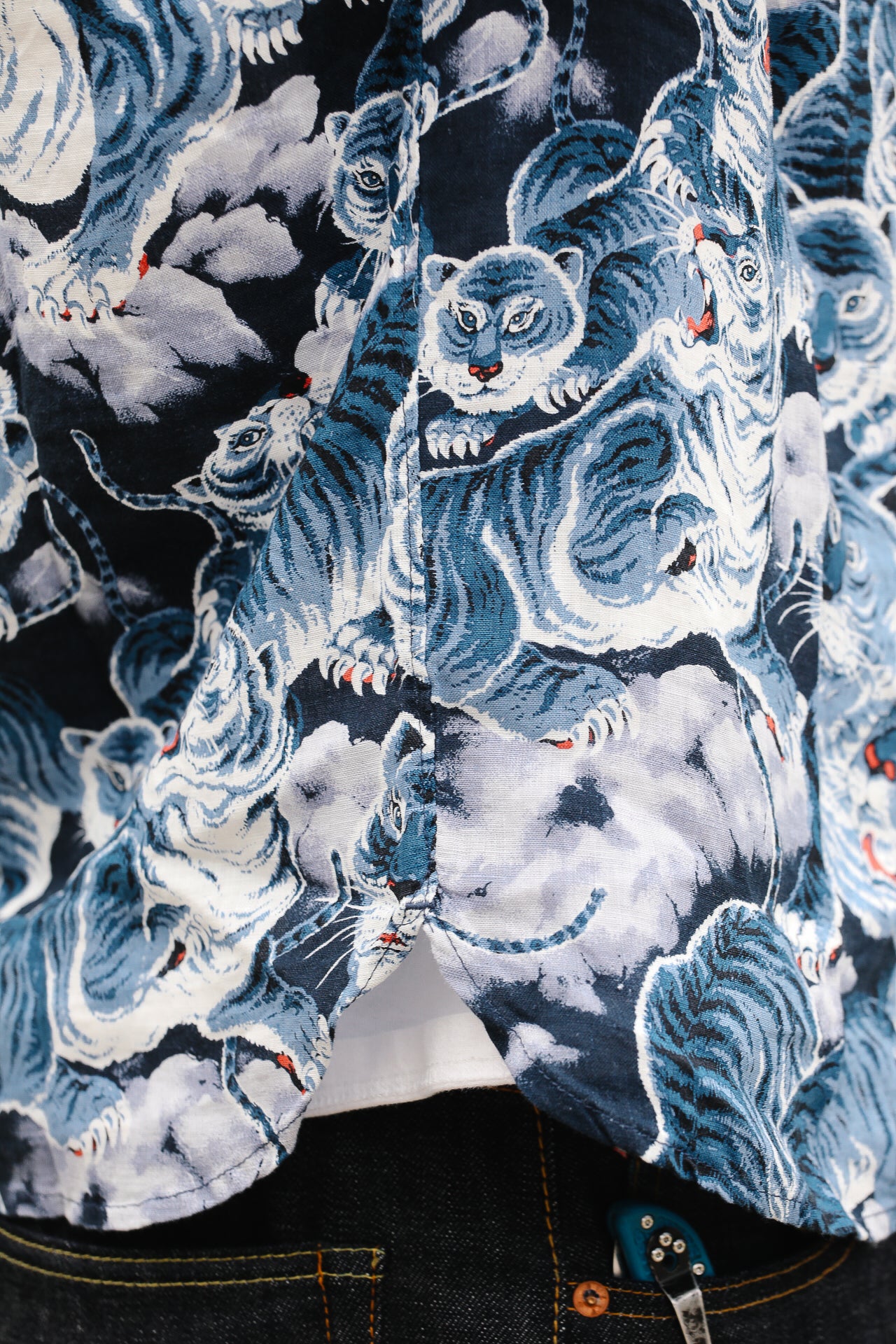 Close-up of a shirt with blue tiger print on a dark background