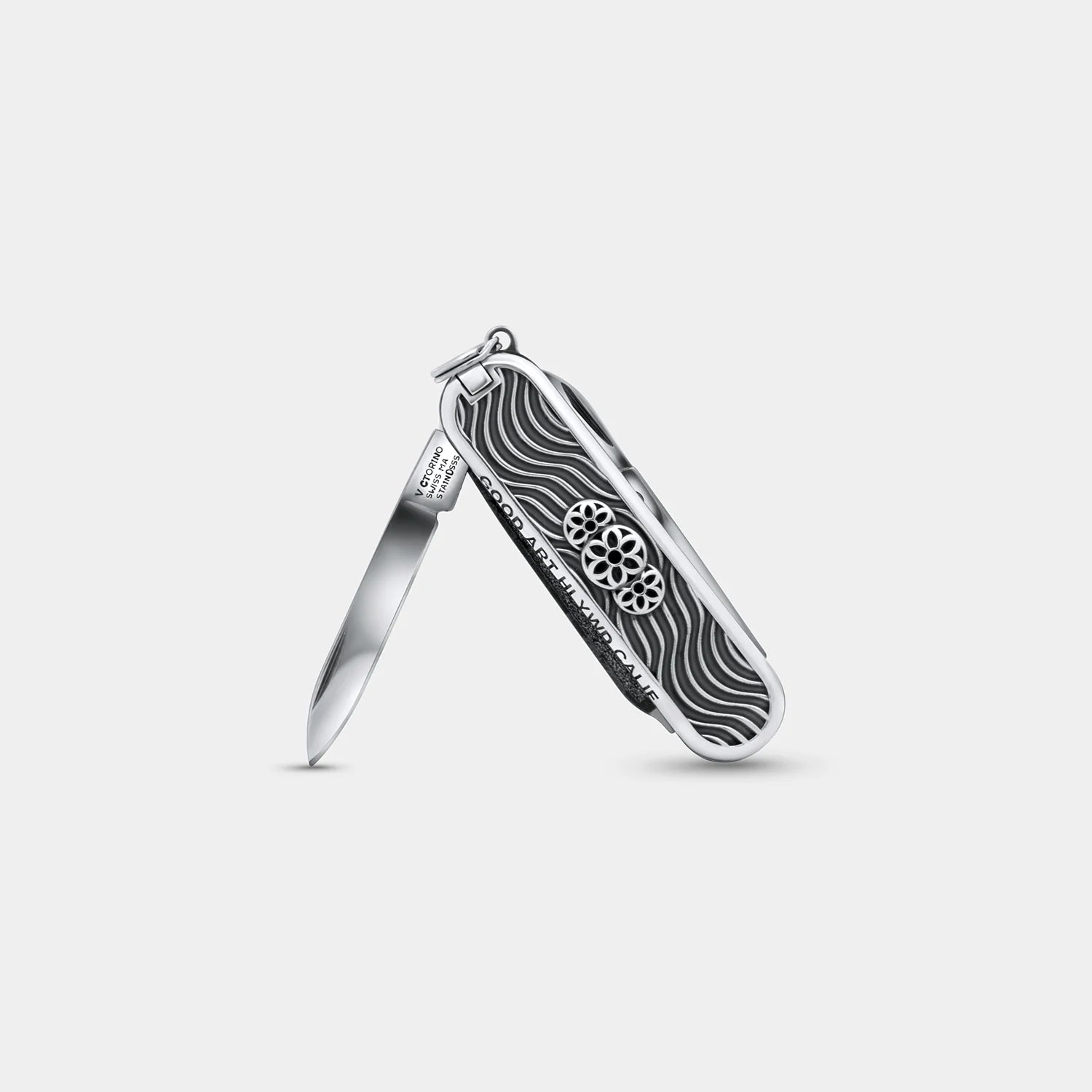 Open Victorinox Good Art pocket knife with decorative black and silver wave pattern handle