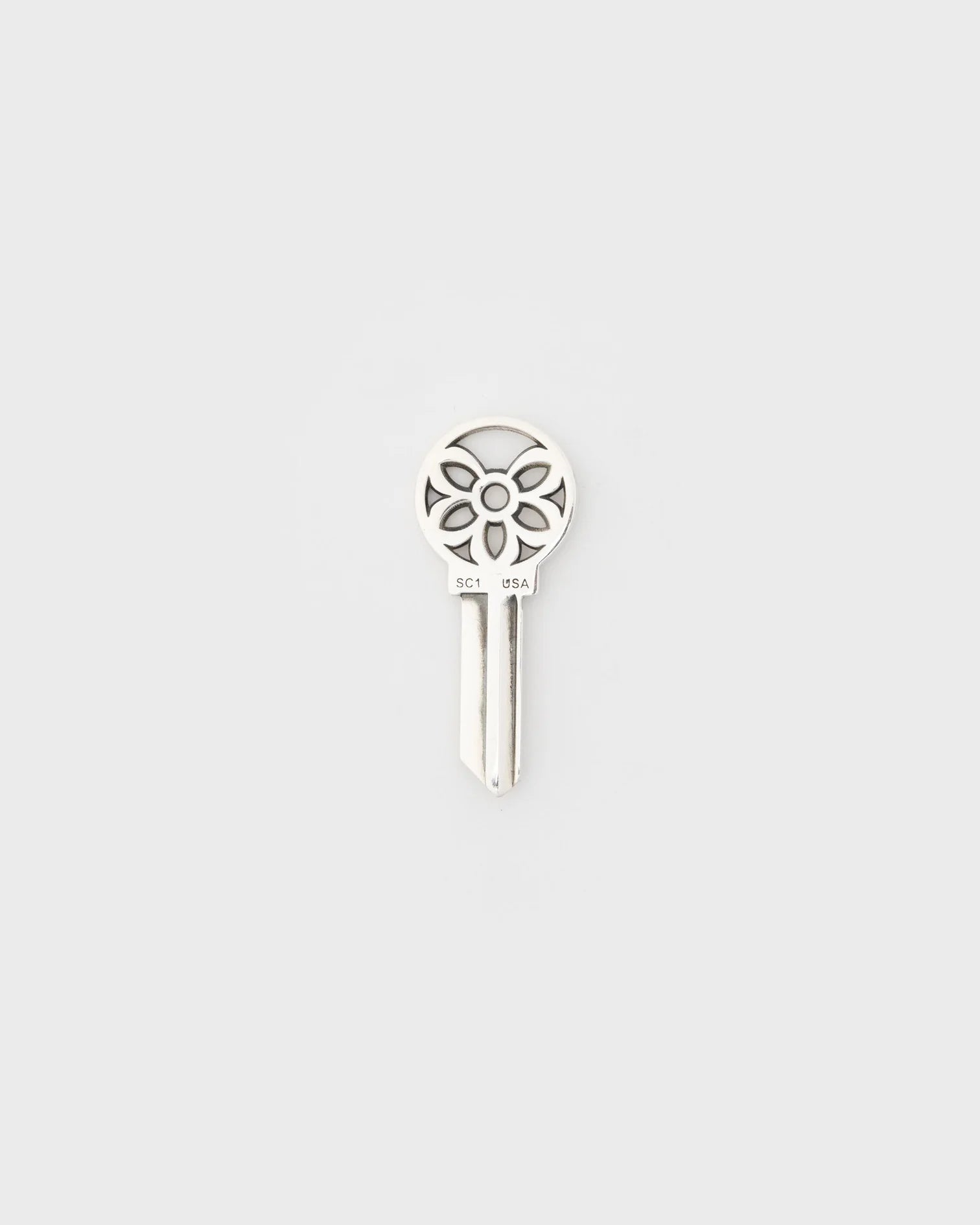 Sterling silver American house key with decorative rosette design and SC1 USA engraving