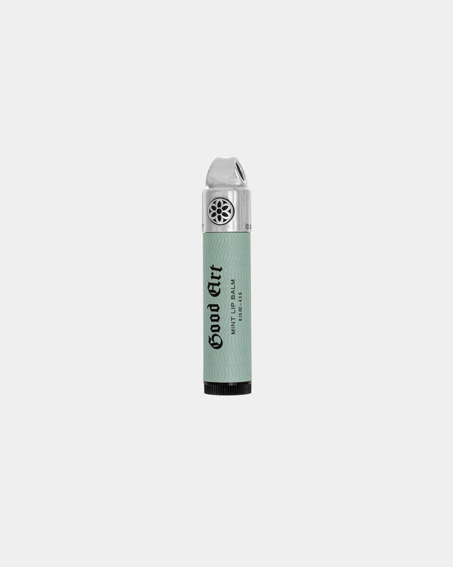 Good Art Mint Lip Balm with sterling silver cap and floral cutout design on light green packaging