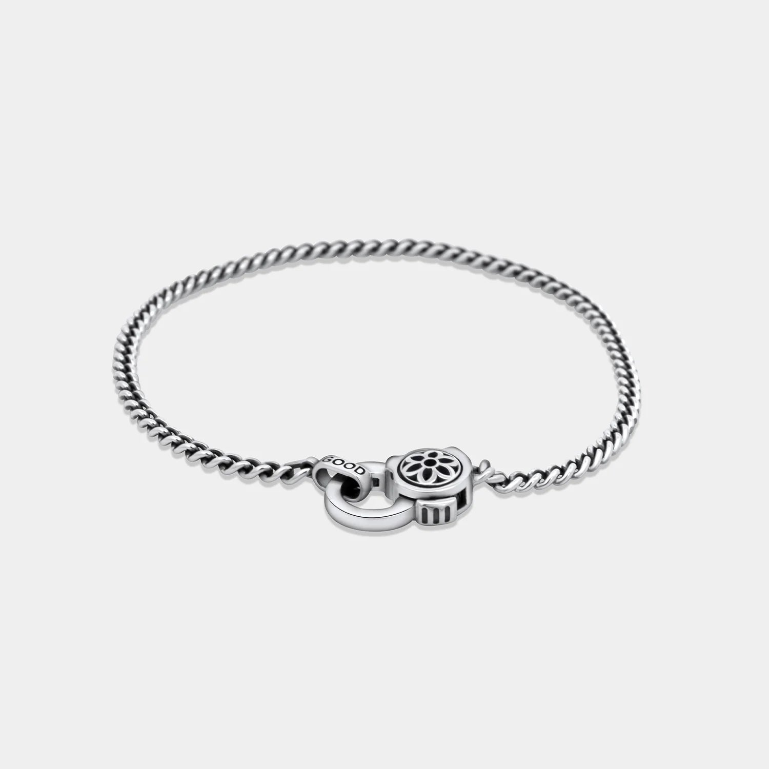 Sterling silver curb chain bracelet with intricate floral-patterned clasp by Good Art