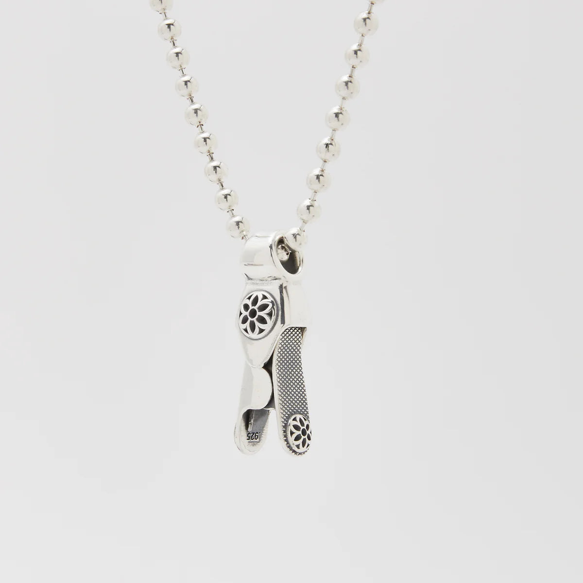 Sterling silver pendant necklace with detailed floral patterns on ball chain from Iron Shop Provisions