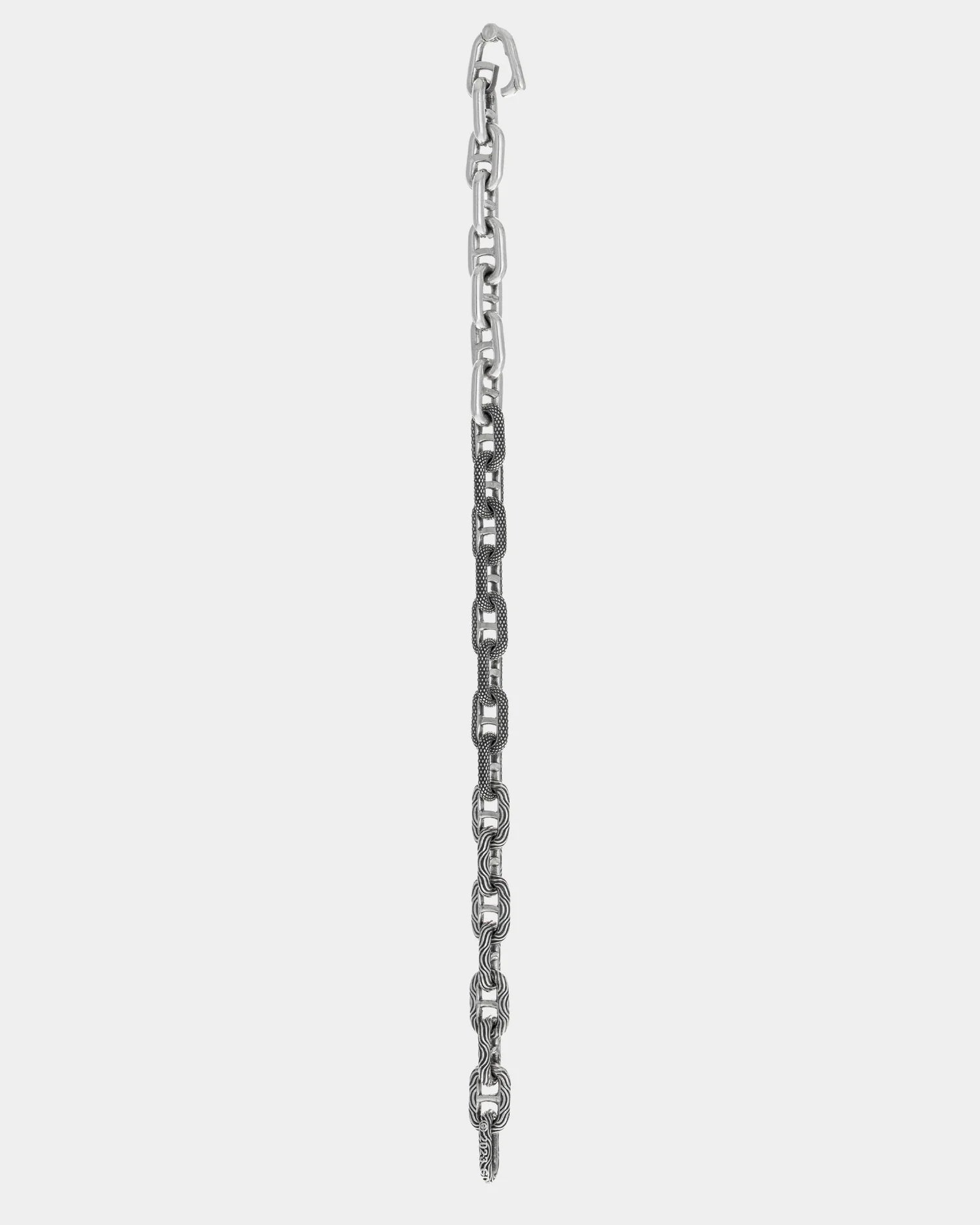 Sterling silver bracelet with mixed motif chain links, including smooth and textured patterns, showcased on white background