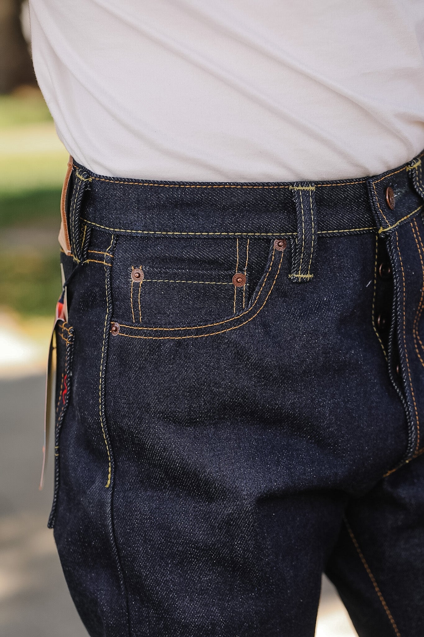 Close-up of dark blue jeans with a blurred background