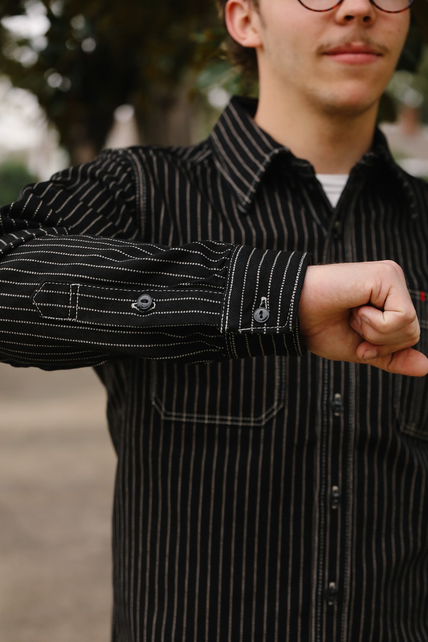 man wearing IHSH-266-IND 12oz Wabash Work Shirt - Indigo With Black Buttons showing sleeve 