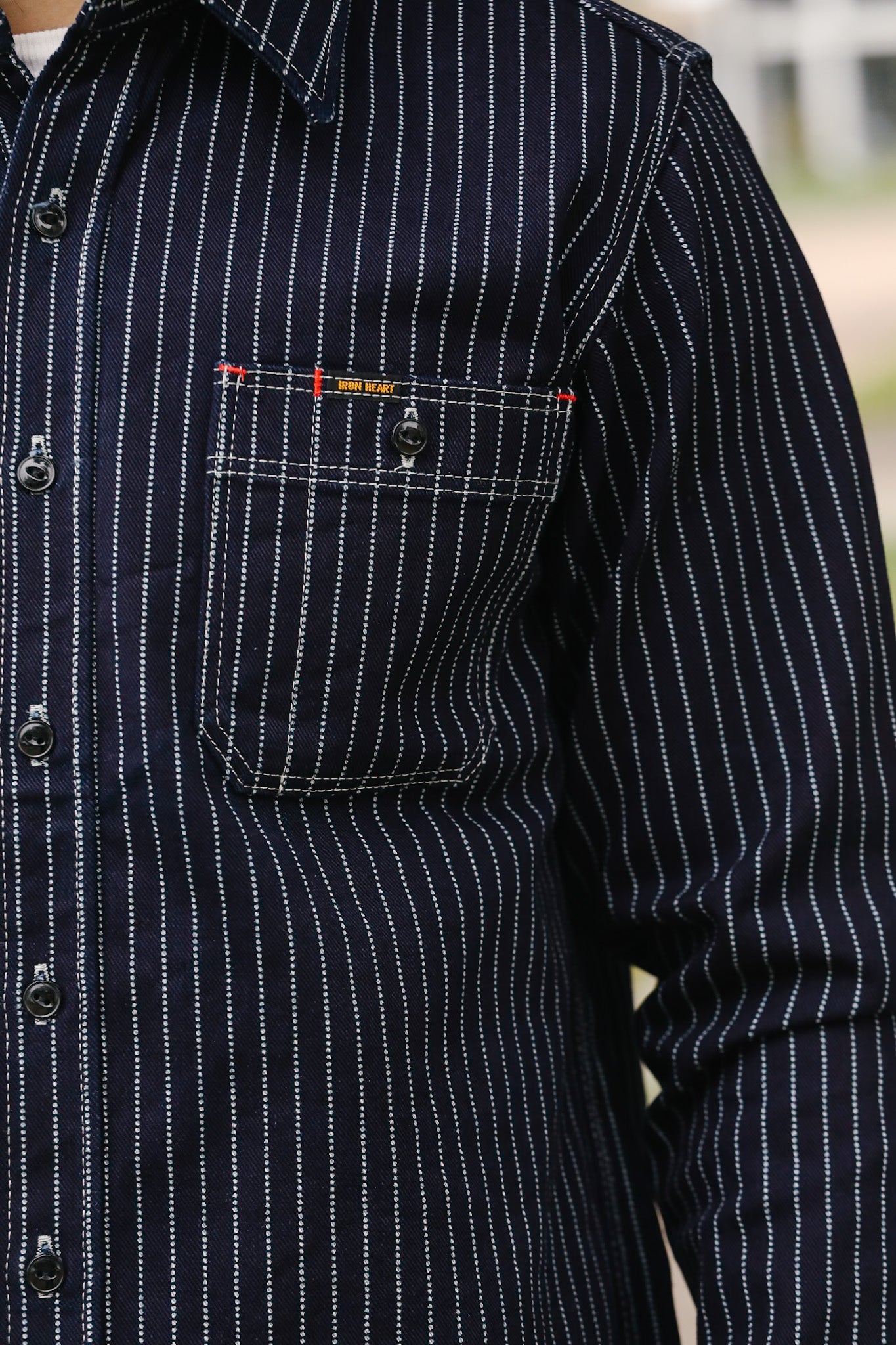 man wearing IHSH-266-IND 12oz Wabash Work Shirt - Indigo With Black Buttons showing pocket 