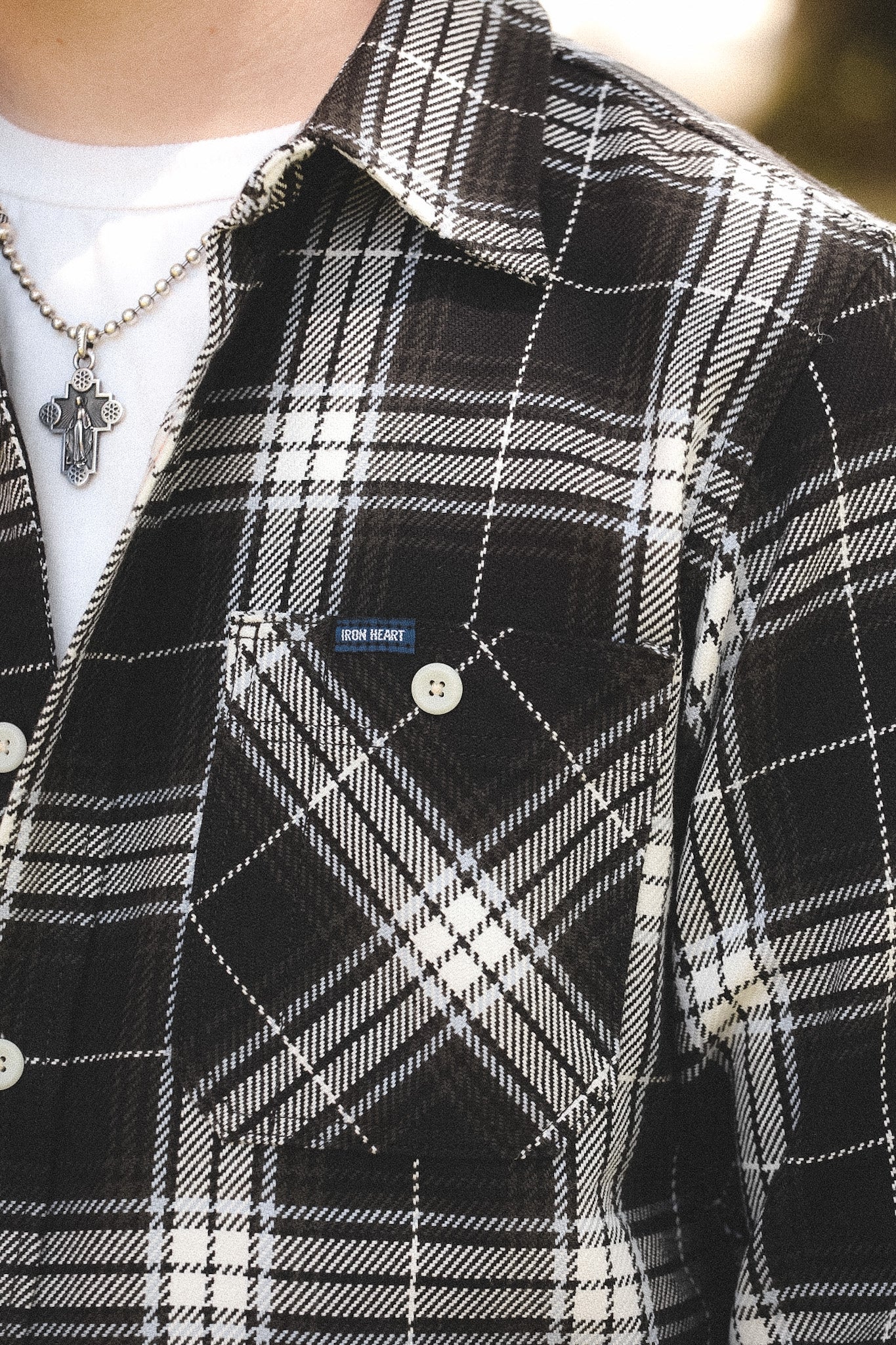 detail of plaid black shirt outdoors on a blurred background 