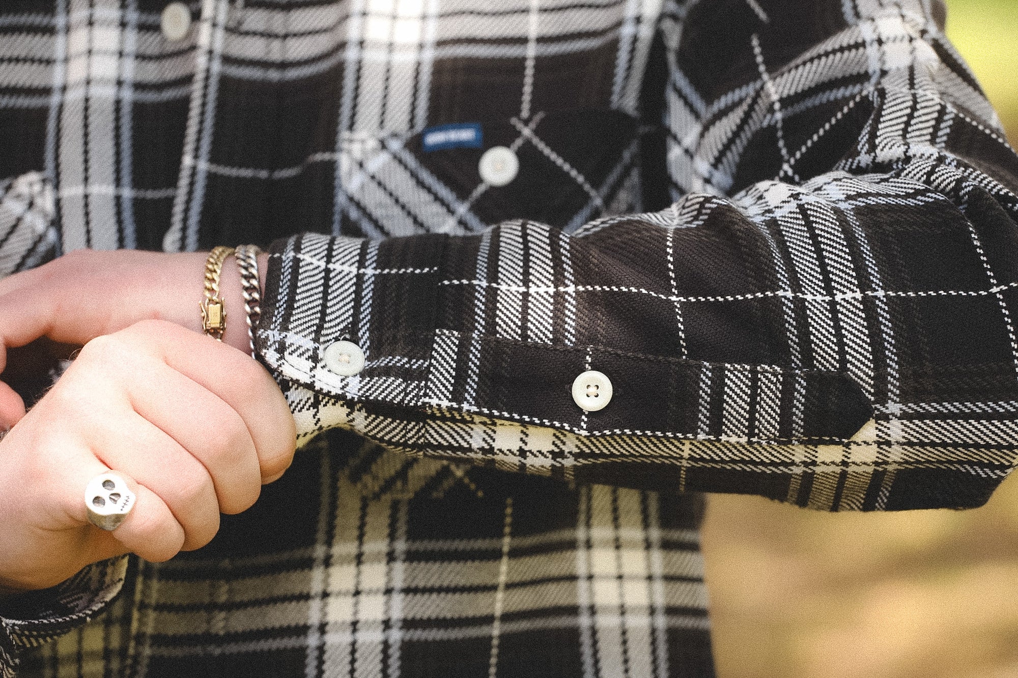 detail of plaid black shirt outdoors on a blurred background 