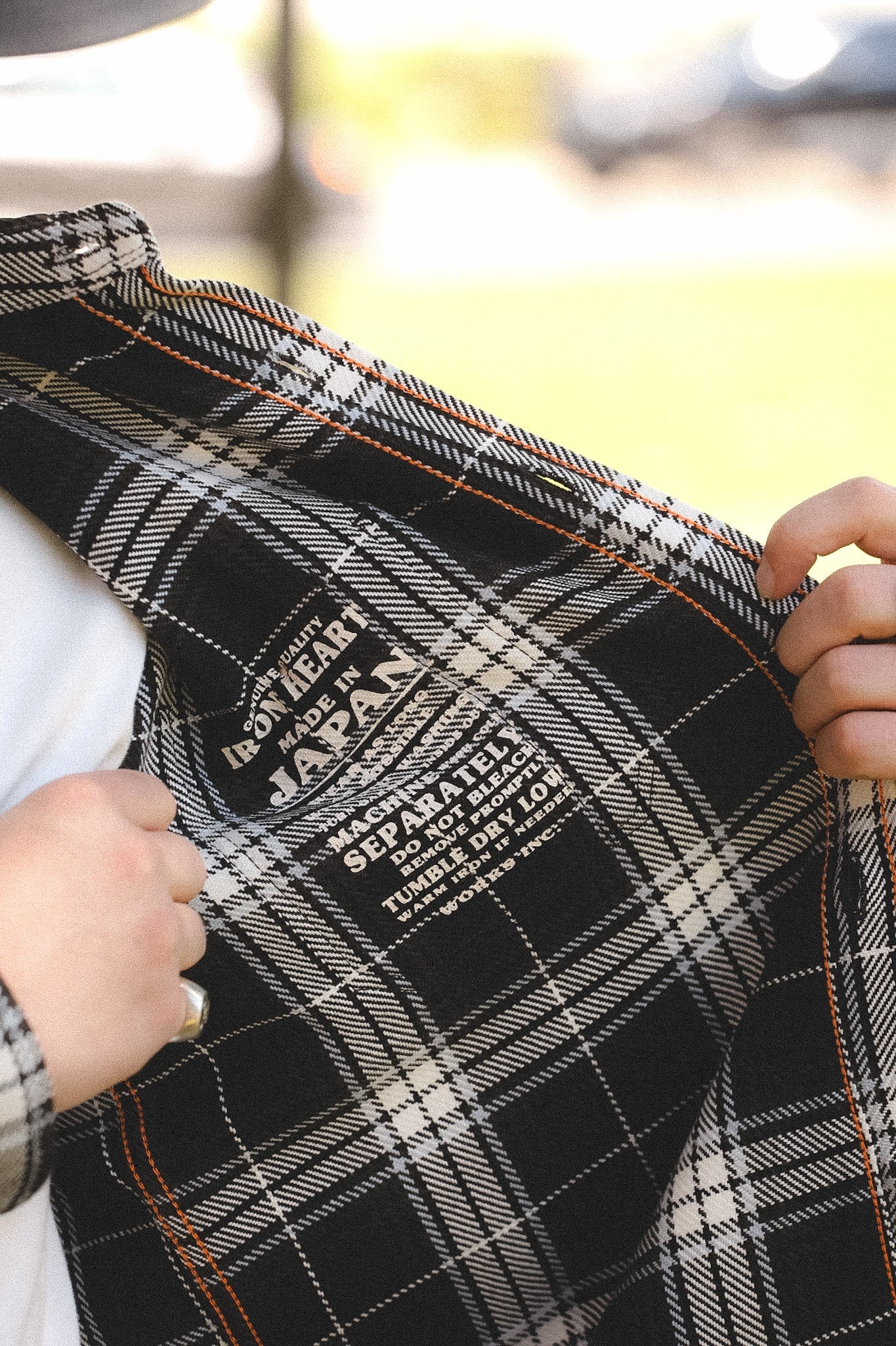 detail of plaid black shirt outdoors on a blurred background 