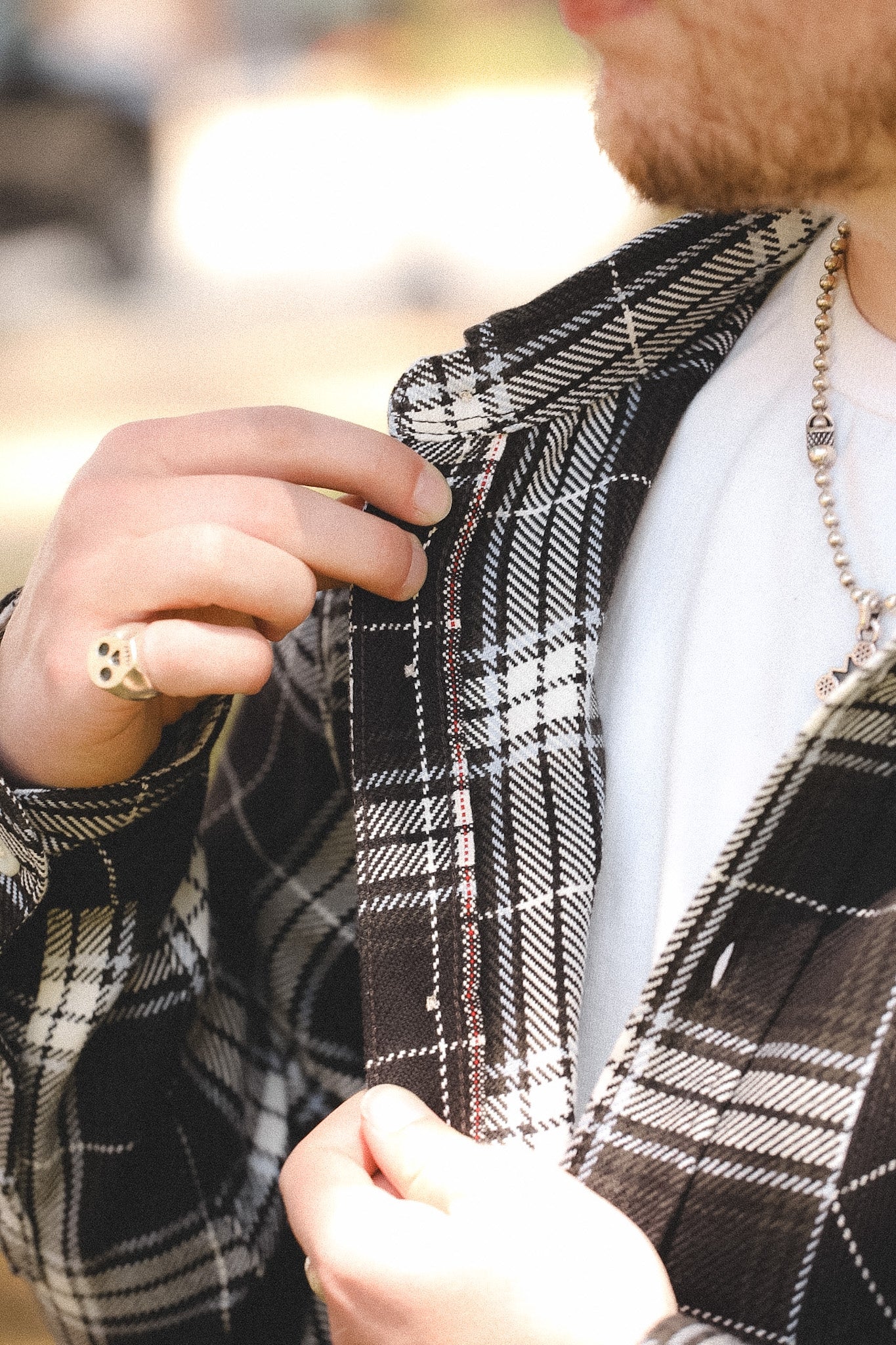 detail of plaid black shirt outdoors on a blurred background 