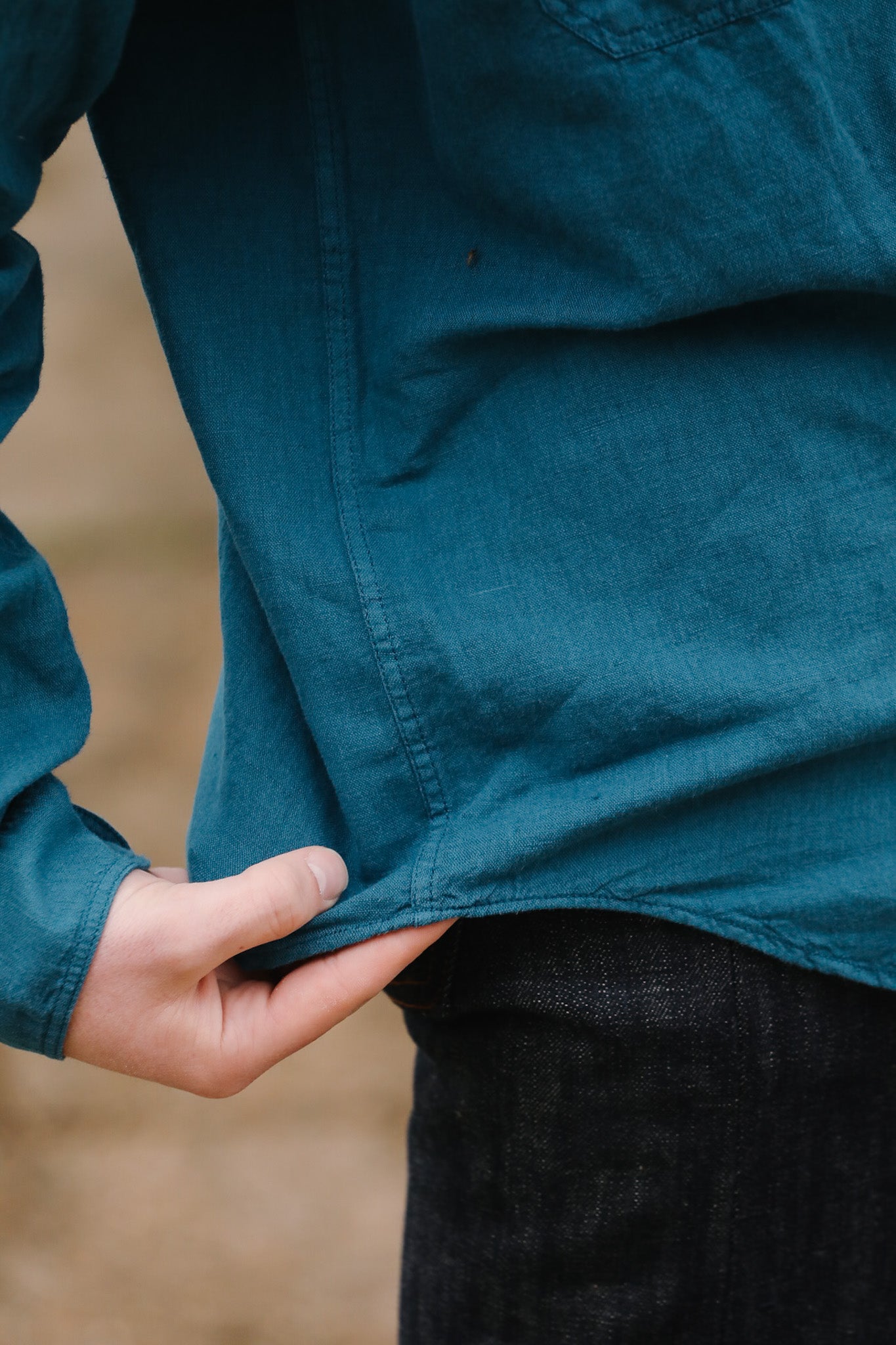 Person wearing a blue jacket with a blurred background
