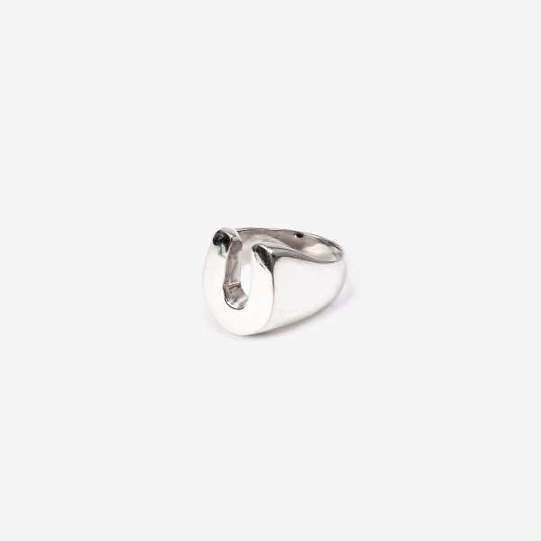 Polished silver horseshoe-shaped ring on white background, minimalist design from Iron Shop Provisions