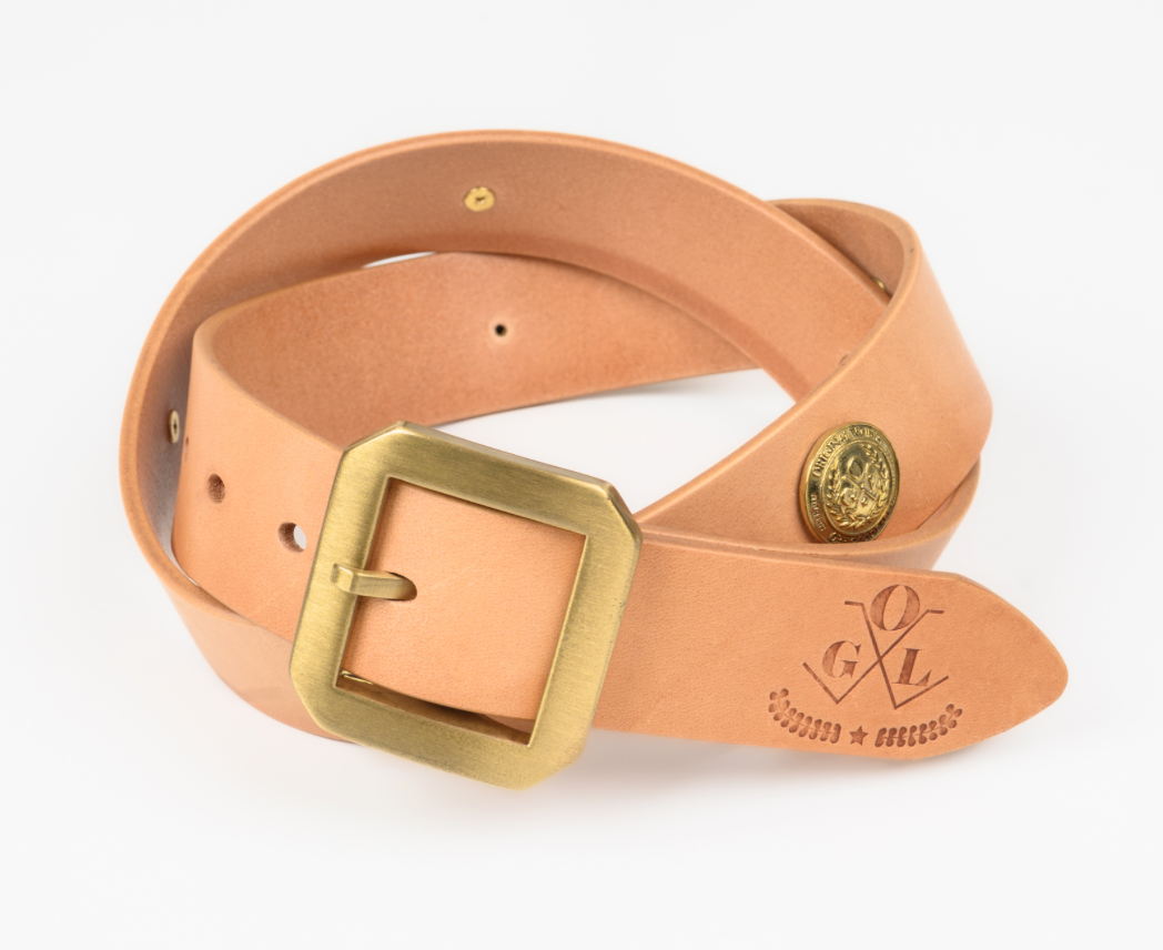 Tan leather belt with brass buckle on a white background