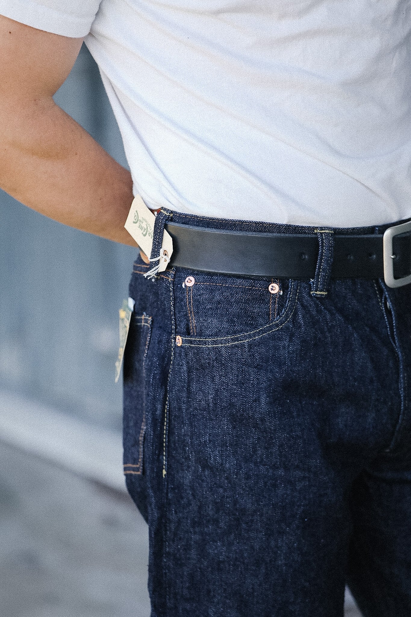 Person wearing blue jeans with a blurred background