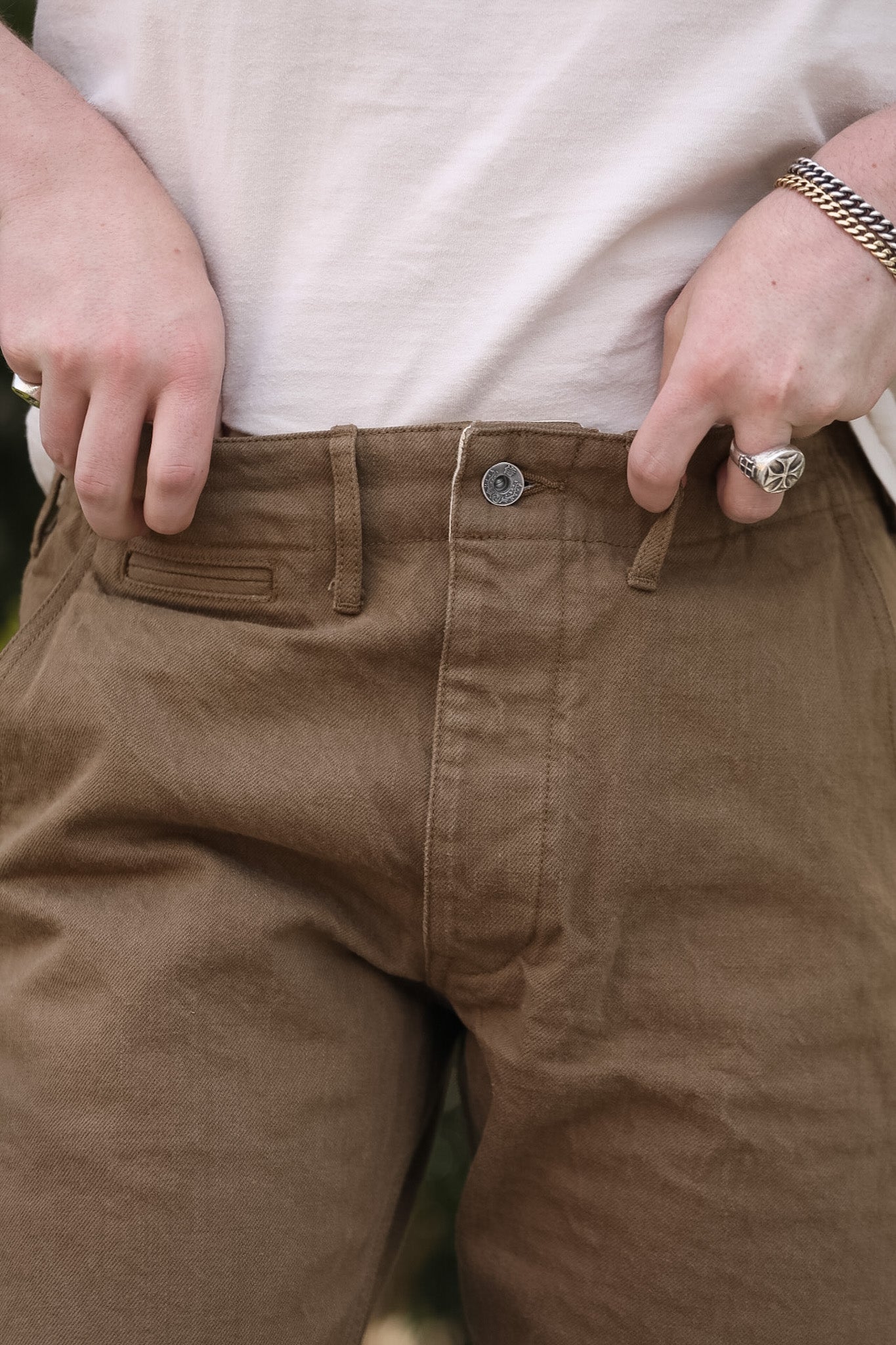 Brown pants with a white shirt worn by a person.