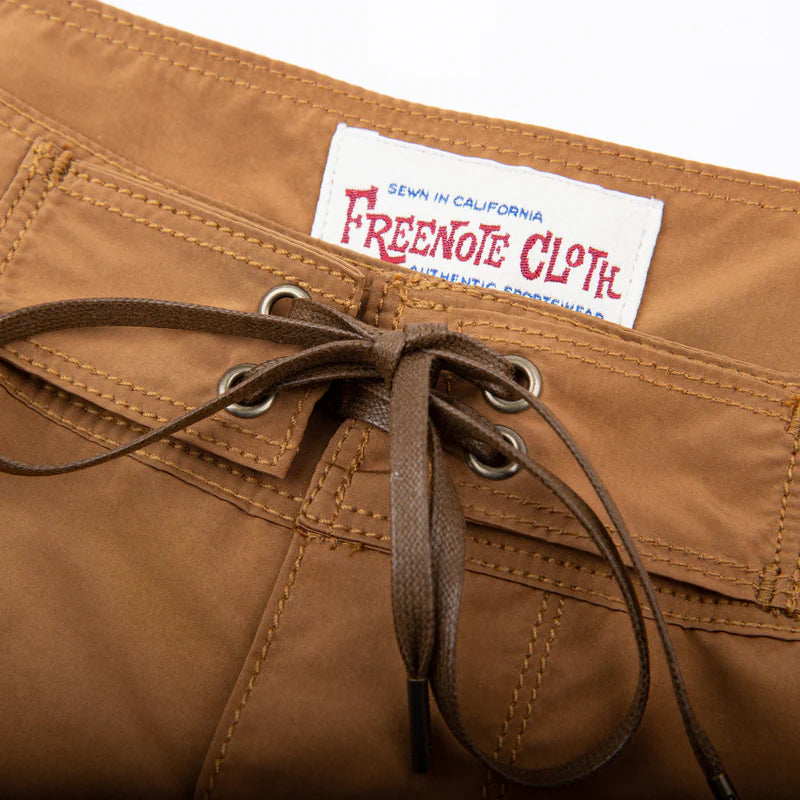 Close-up of brown leather laced waistband with Freenote Cloth label sewn on inside waist