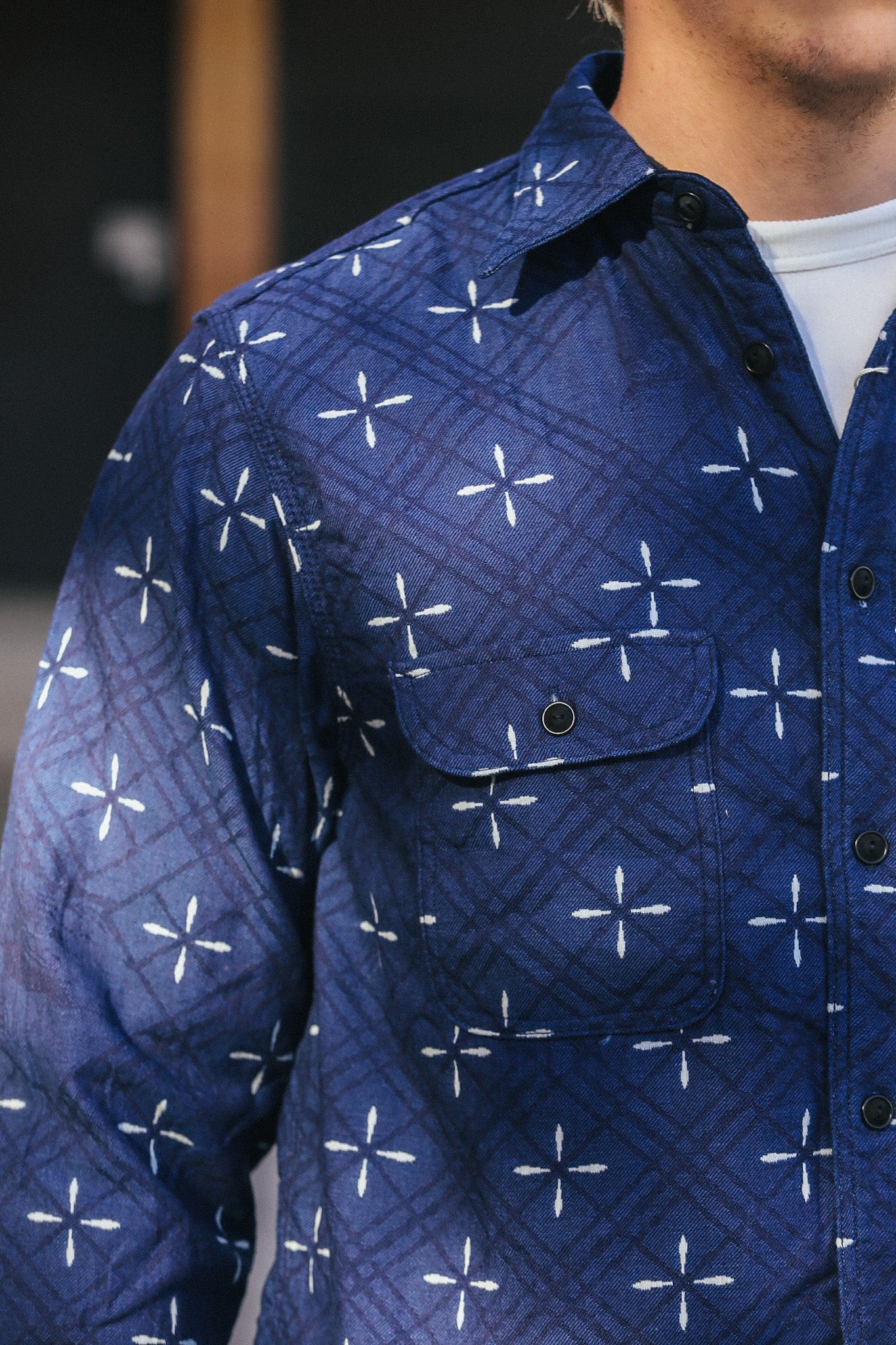 Close-up of indigo blue jacquard work shirt with white cross patterns and black buttons from Iron Shop Provisions