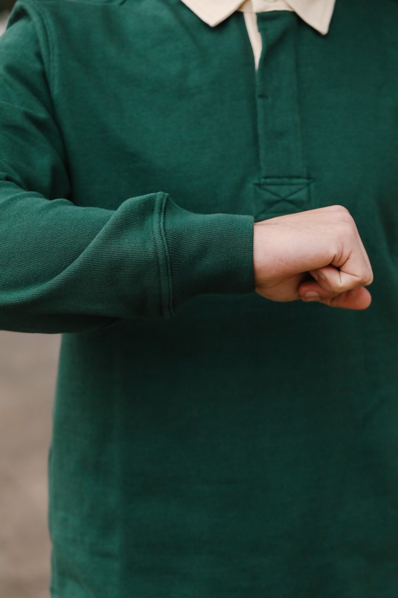 Person wearing a green shirt with a blurred background