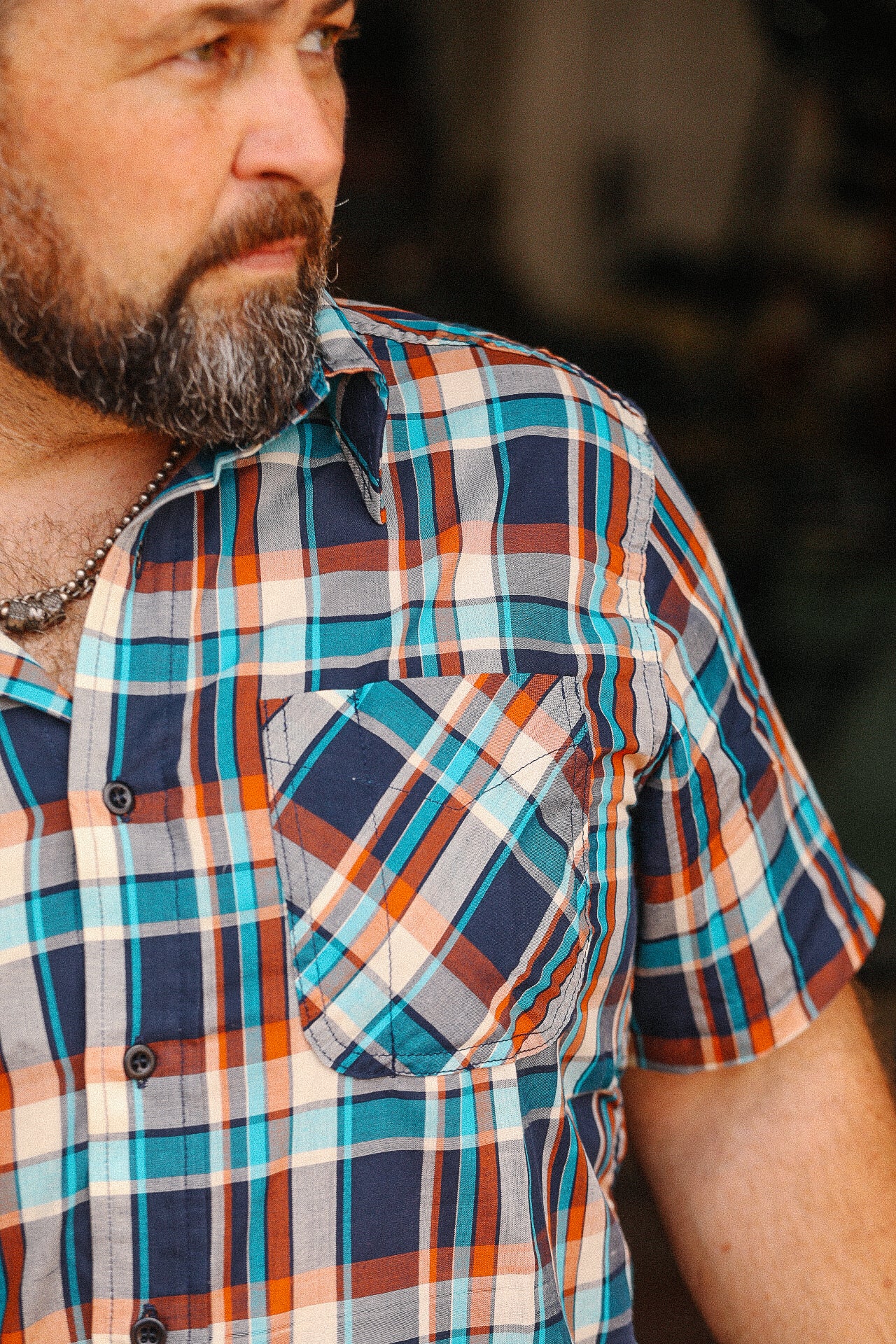 Bearded man wearing turquoise and orange short sleeve madras plaid shirt from Iron Shop Provisions