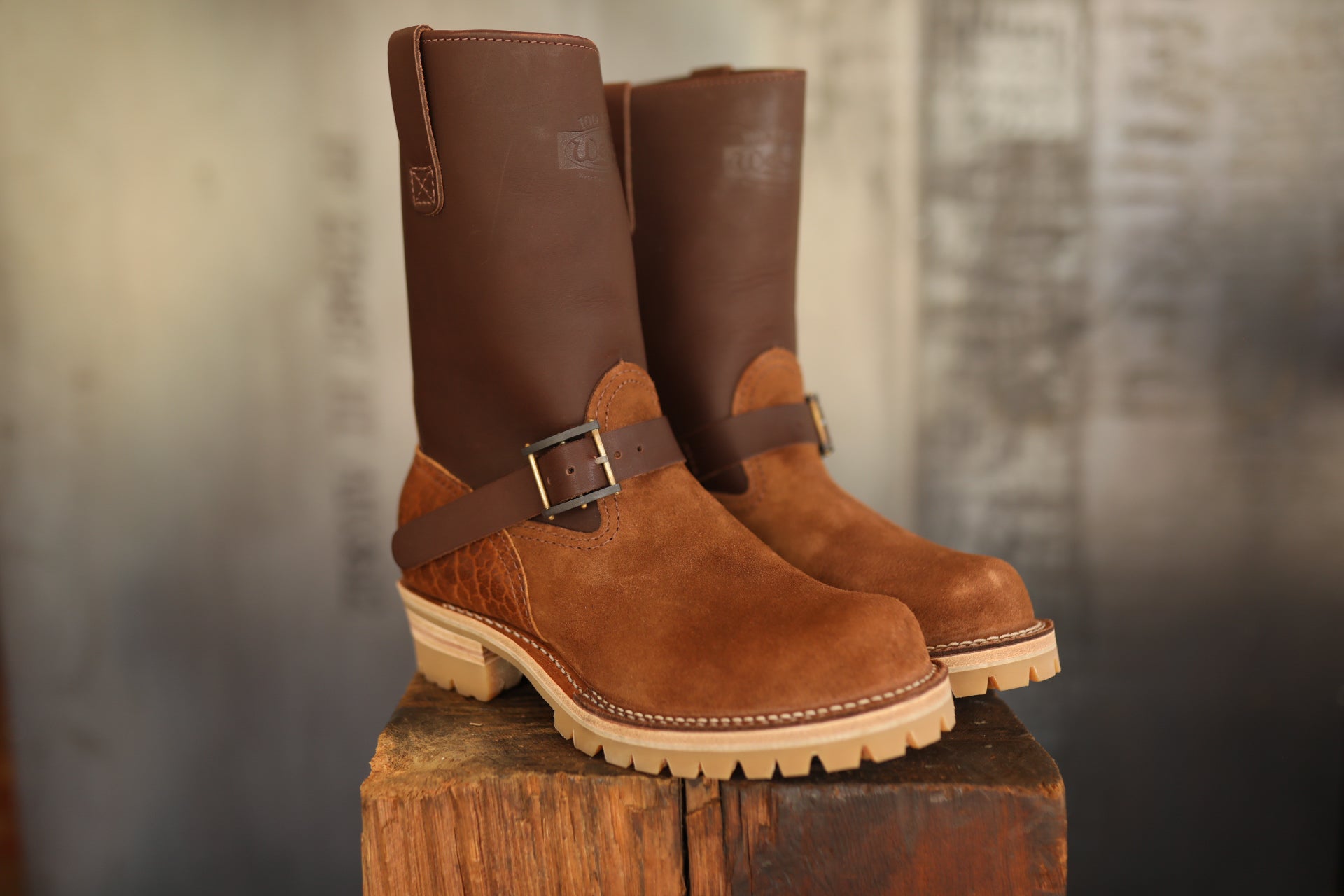 Pair of brown Wesco ISP Boss Engineer boots with leather and suede on wooden block