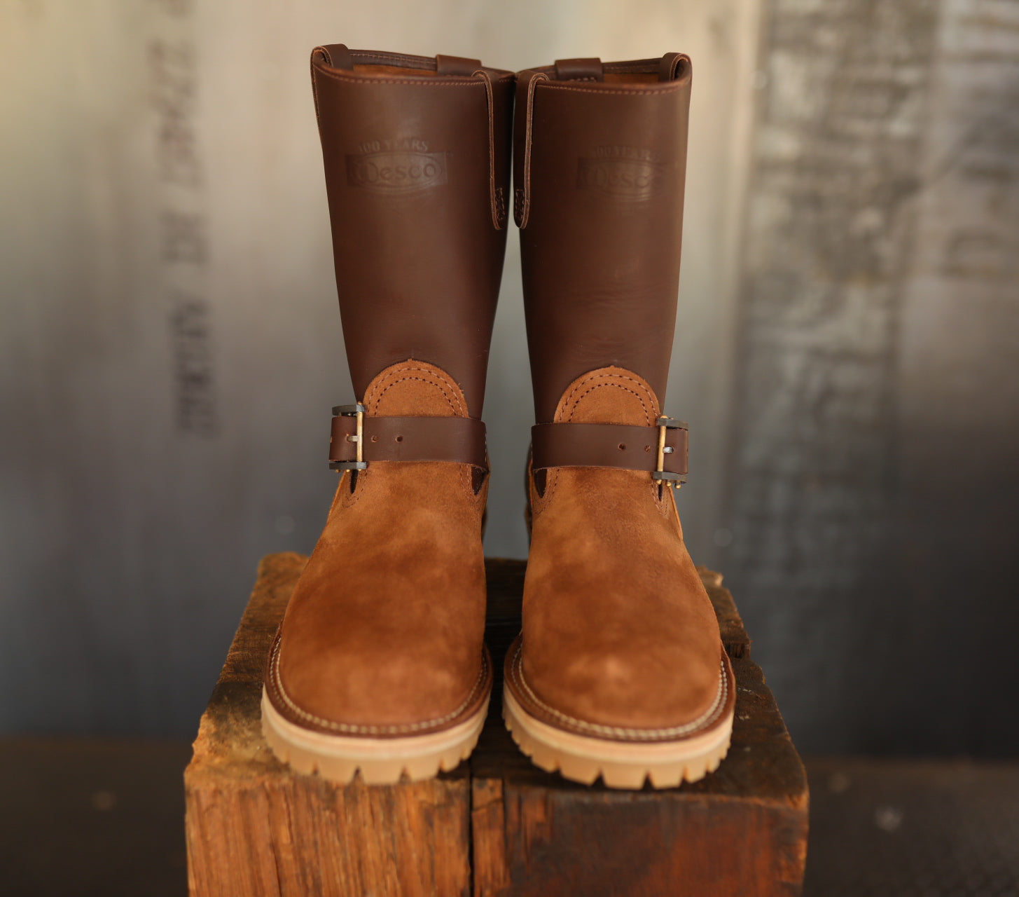 Wesco Boss Engineer boots in brown leather and suede with buckle straps on wooden block