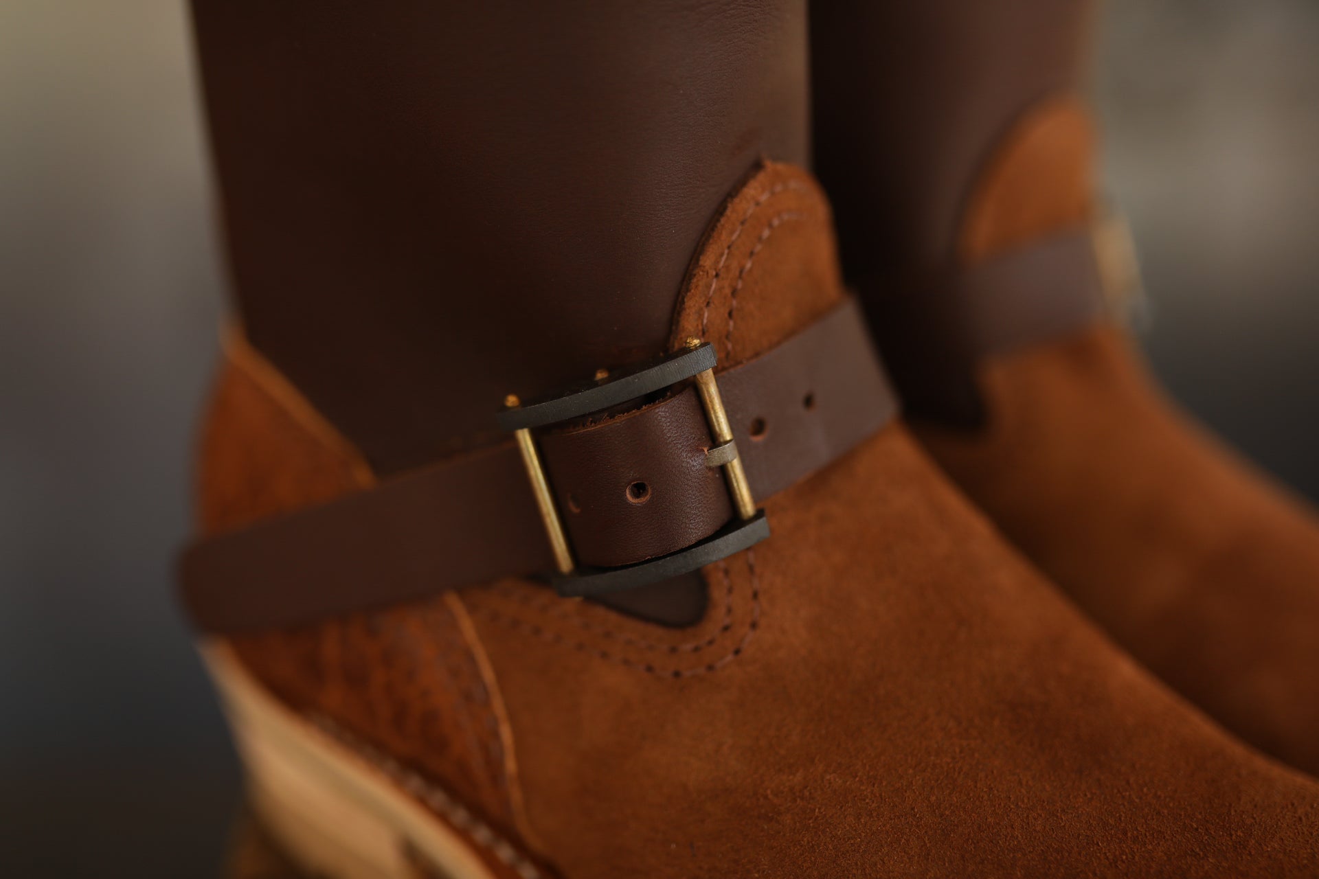 Close-up of brown leather Wesco ISP Boss Engineer boots with suede panels and brass buckle detail
