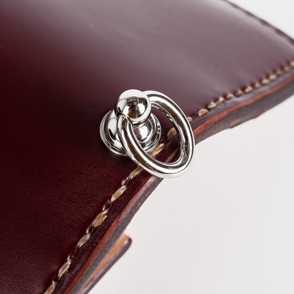 Close-up of polished silver metal ring fastener on stitched burgundy leather from Iron Shop Provisions
