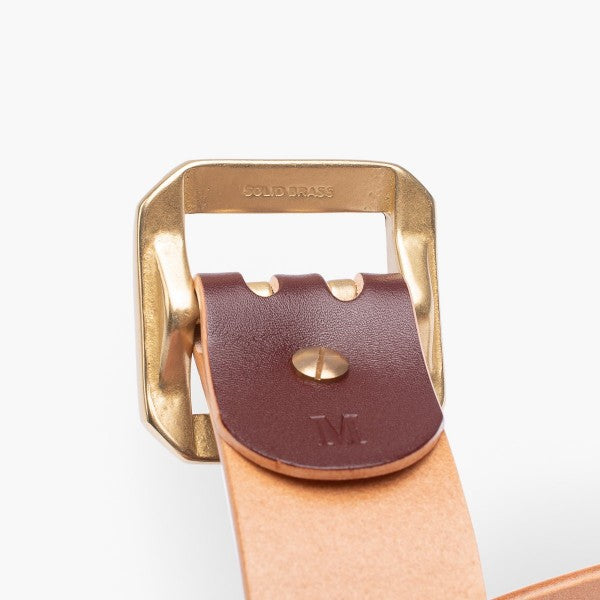 Close-up of solid brass belt buckle and leather strap with rivet detail, Iron Shop Provisions style