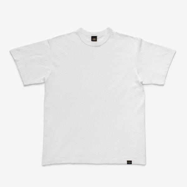 Plain white short-sleeve crew neck t-shirt with a black label near the hem, studio background