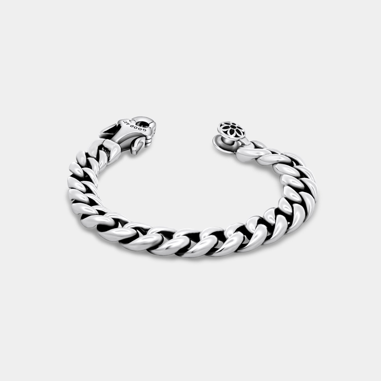 Polished silver chain bracelet with detailed clasp and flower-patterned button from Iron Shop Provisions