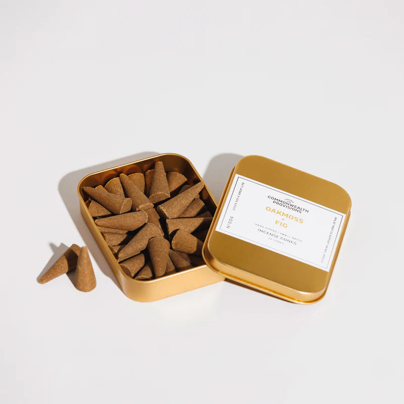 Gold tin container of oakmoss fig incense cones from Iron Shop Provisions on white background