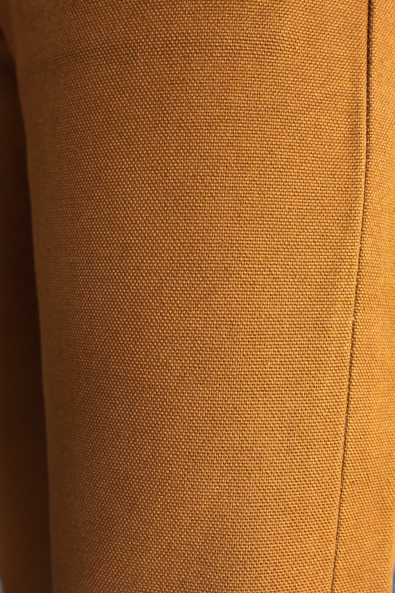 Close-up of durable brown textured fabric with a stitched seam, Iron Shop Provisions textile