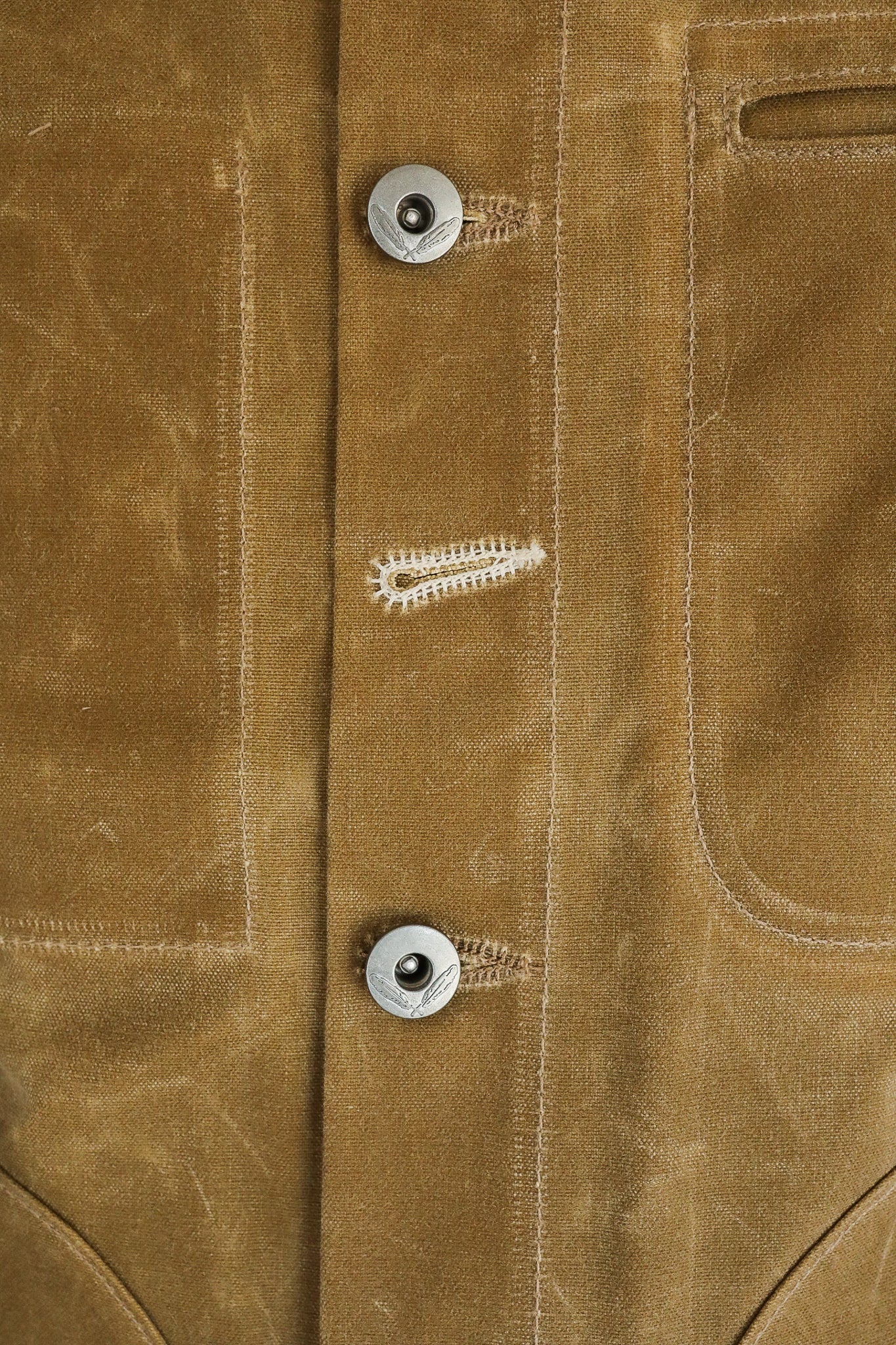 Close-up of brown rugged canvas jacket with silver buttons and stitched buttonholes from Iron Shop Provisions