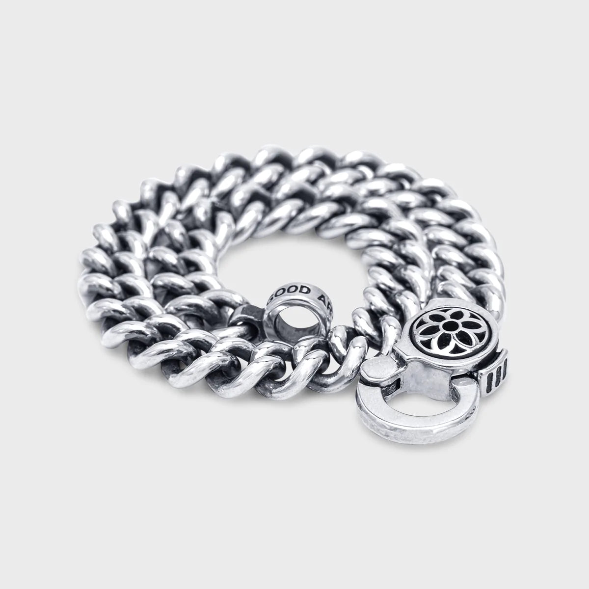 Sterling silver curb chain bracelet with a decorative clasp and engraved ring from Iron Shop Provisions